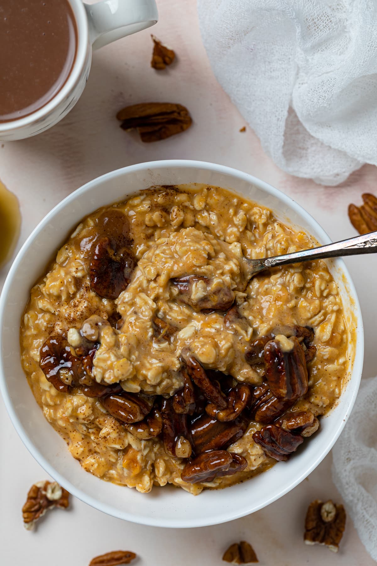 Spoon stirring a bowl of Sweet Potato Pie Overnight Oats.