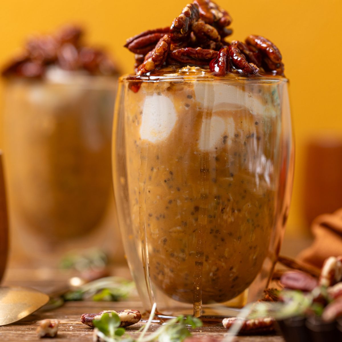 Sweet Potato Pie Overnight Oats in two glasses with topping.