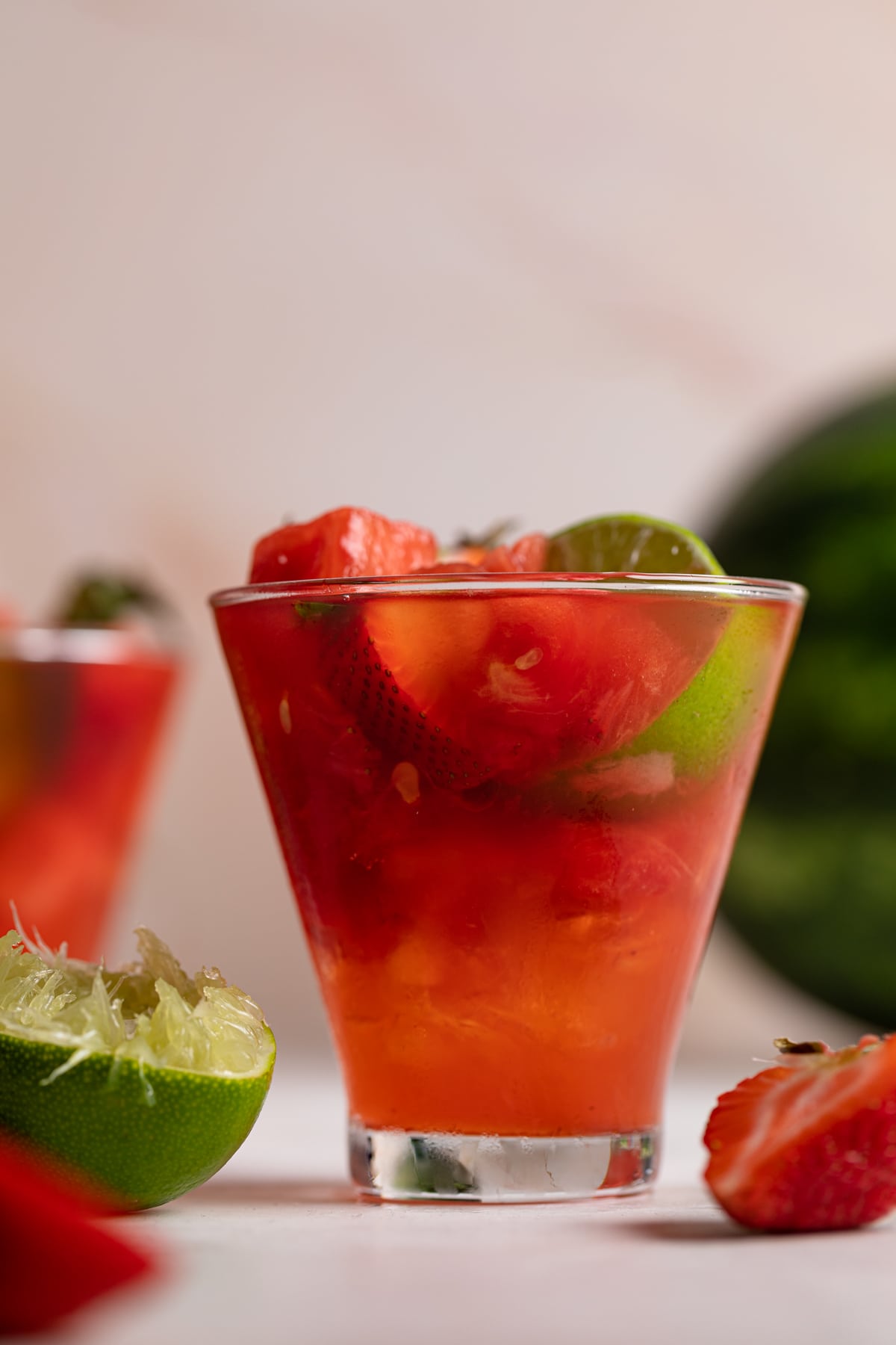 Watermelon Strawberry Lime Mocktail with fresh lime halves.