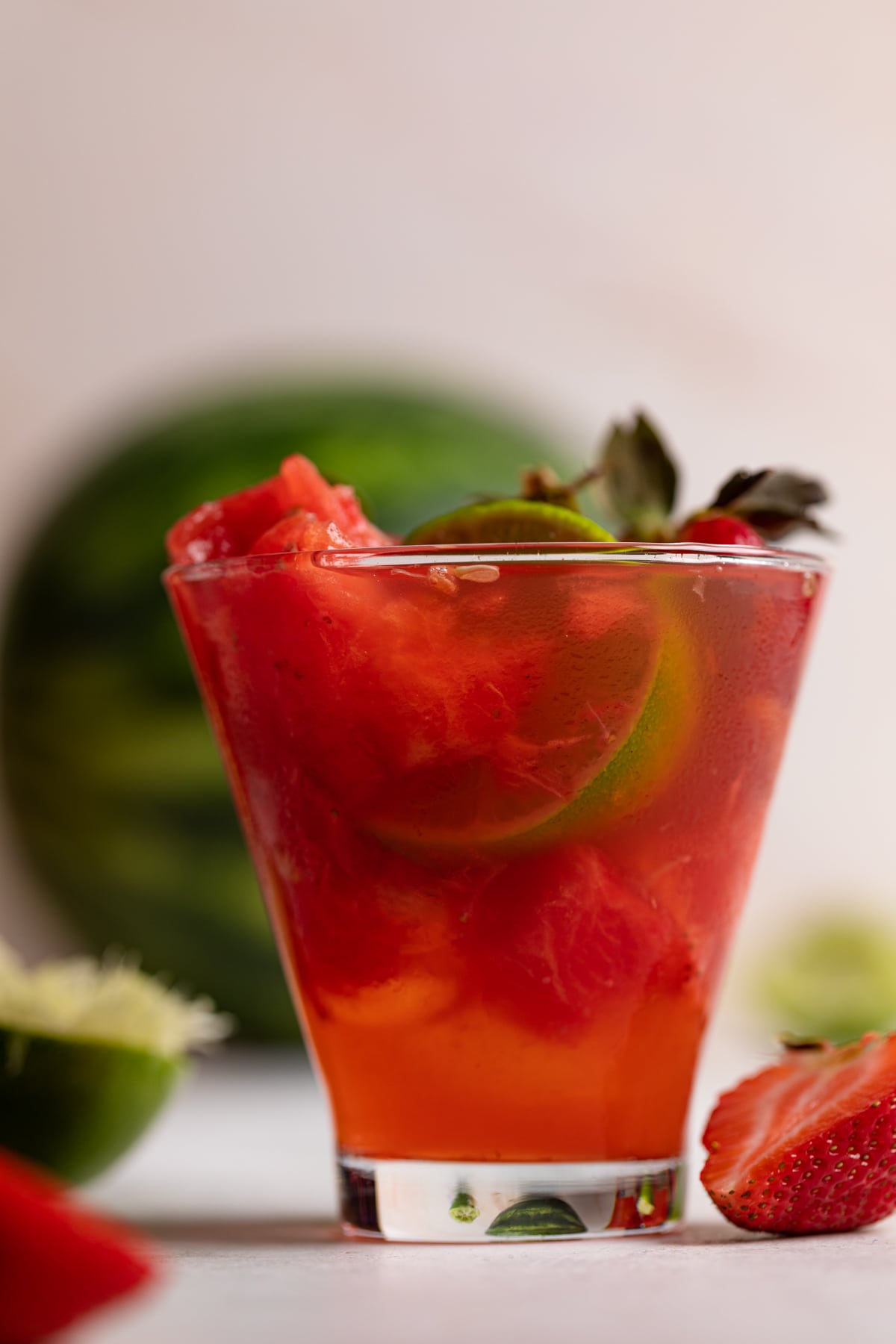 Watermelon Strawberry Lime Mocktail with a half lime inside.