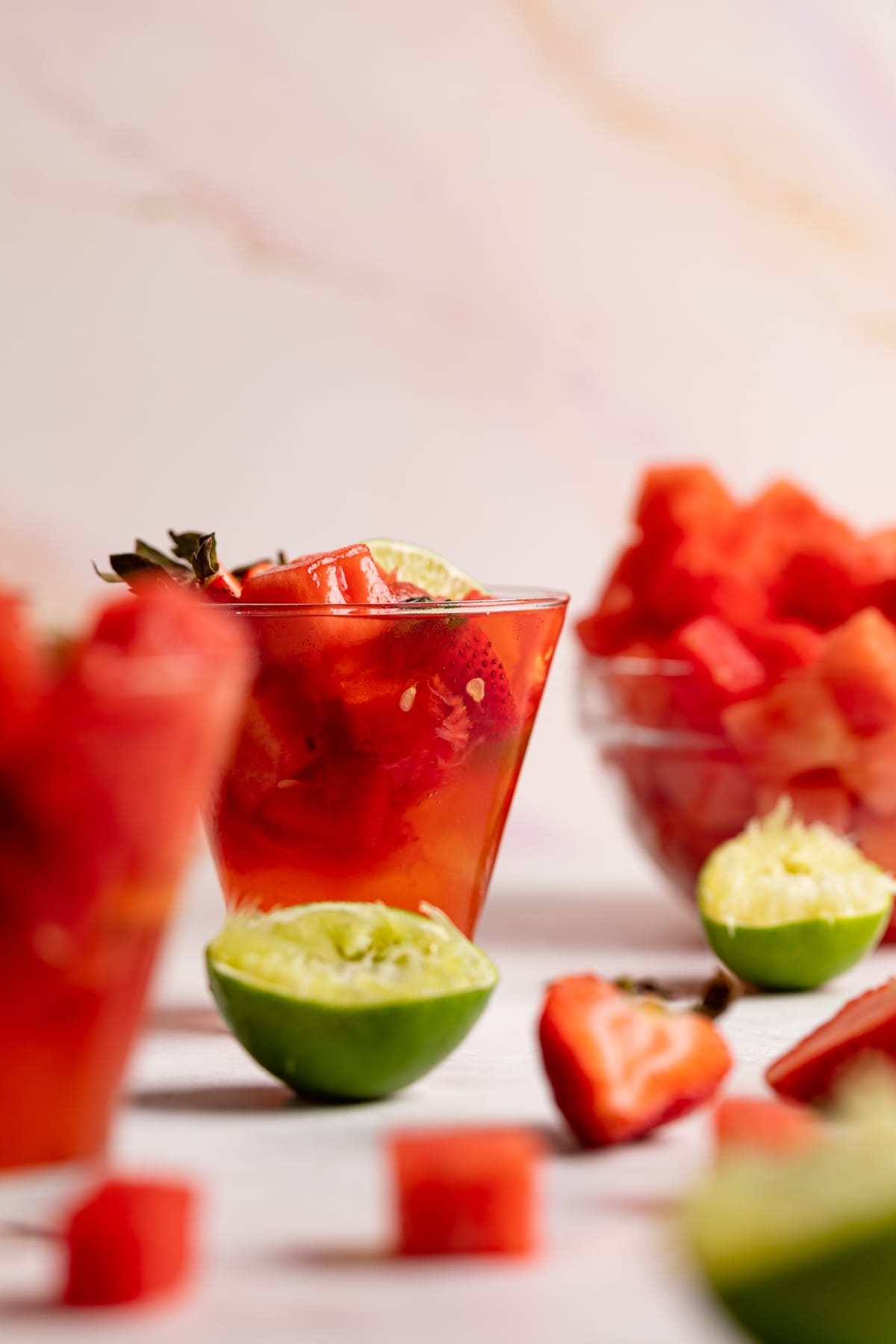 Watermelon Strawberry Lime Mocktail with fresh lime and berries.