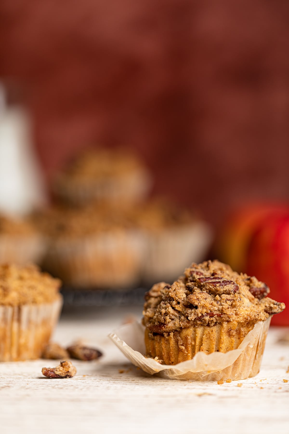 Vegan Apple Spice Muffin with the muffin liner partially peeled off