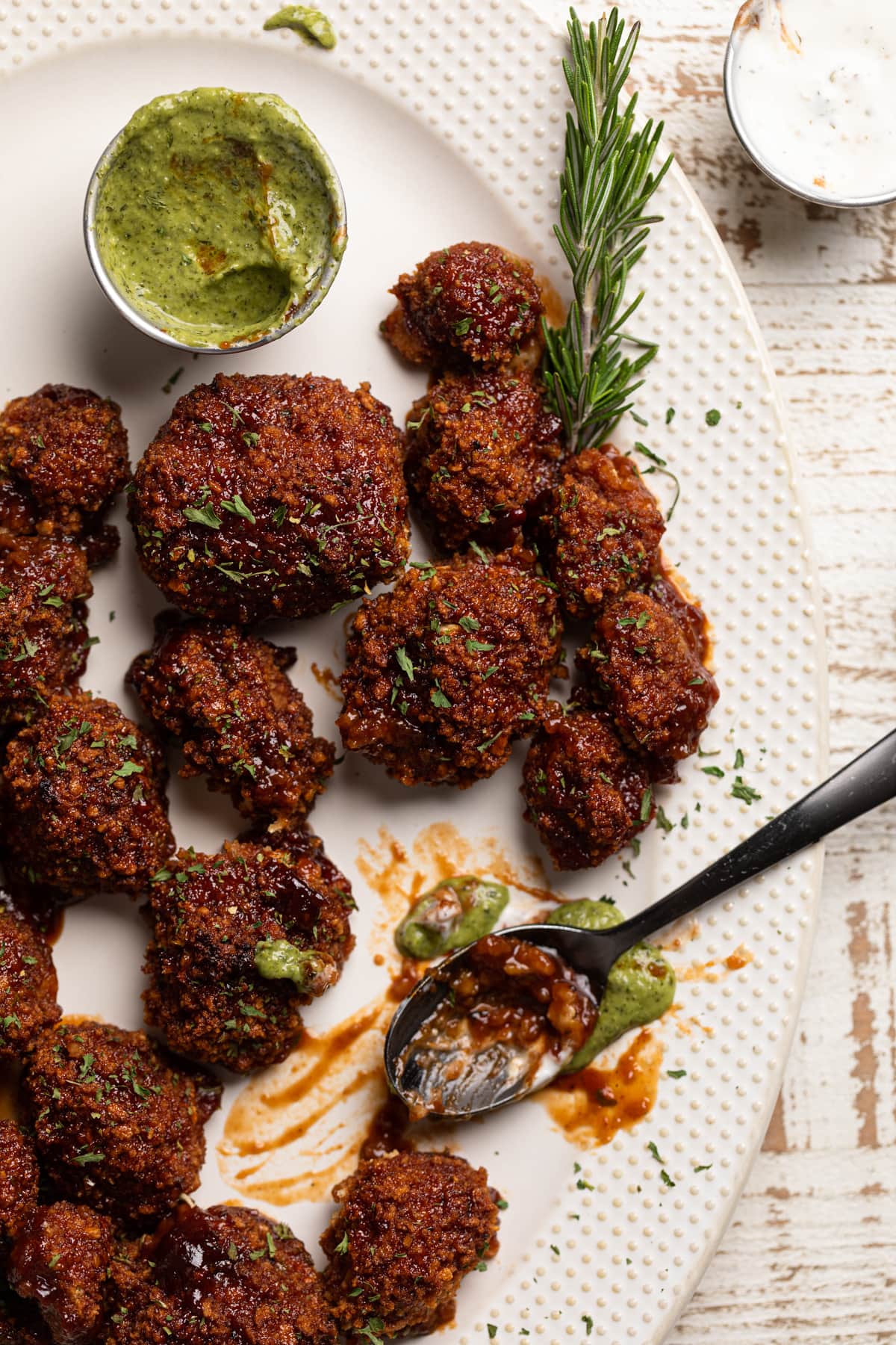 Spoon on a platter of barbeque Cauliflower Wings 