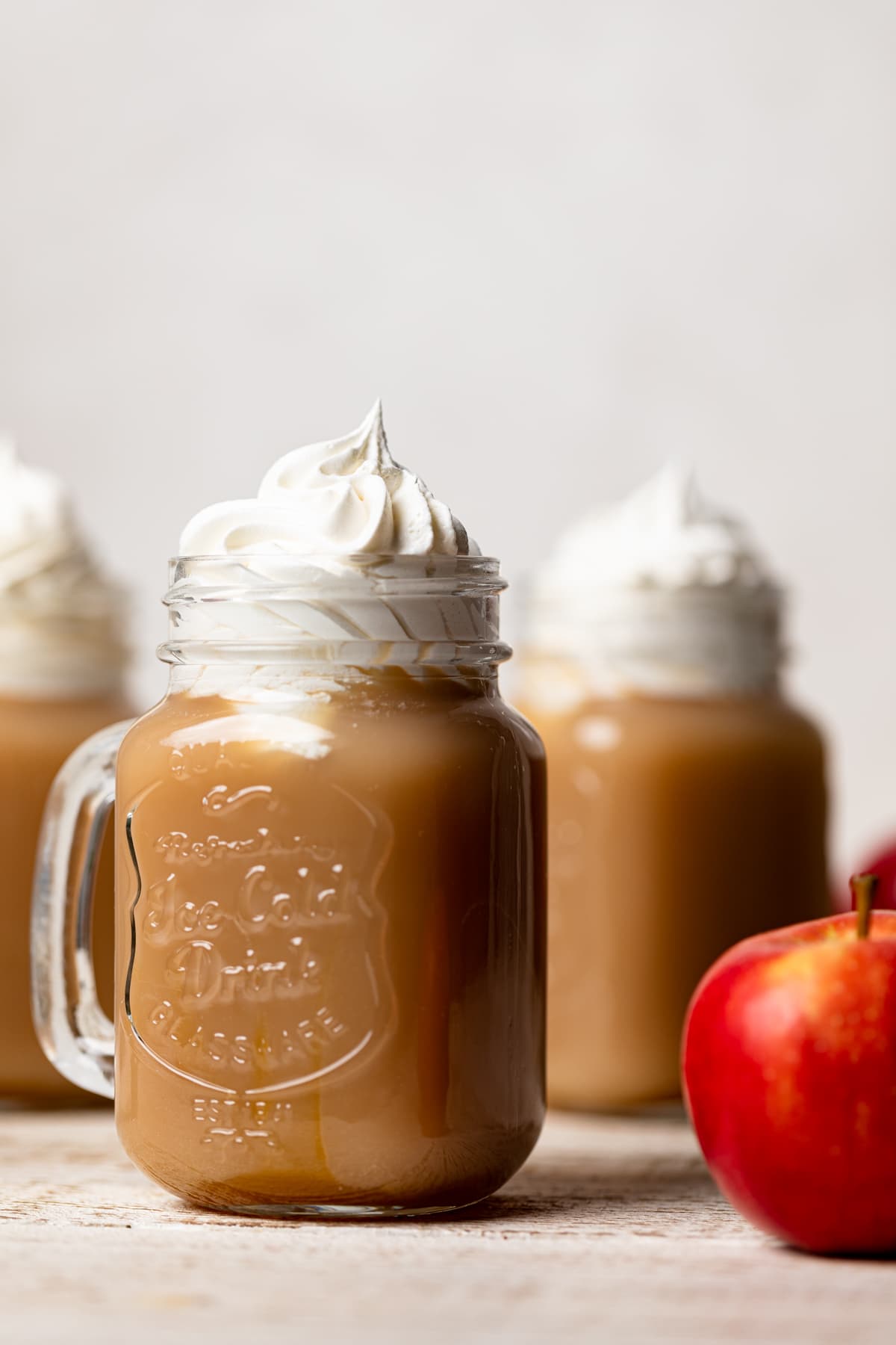 Caramel Apple Cider Drink topped with coconut whipped cream