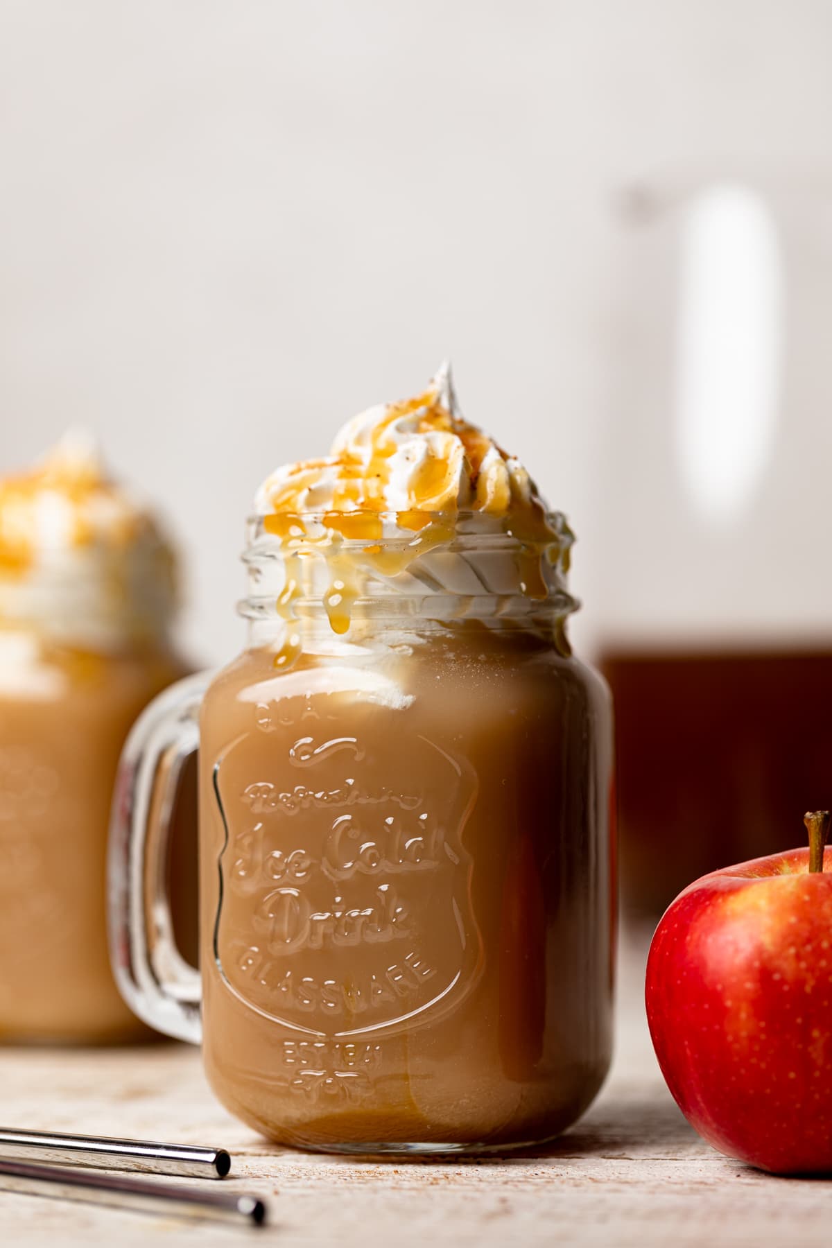 Caramel Apple Cider Drink topped with coconut whipped cream and caramel