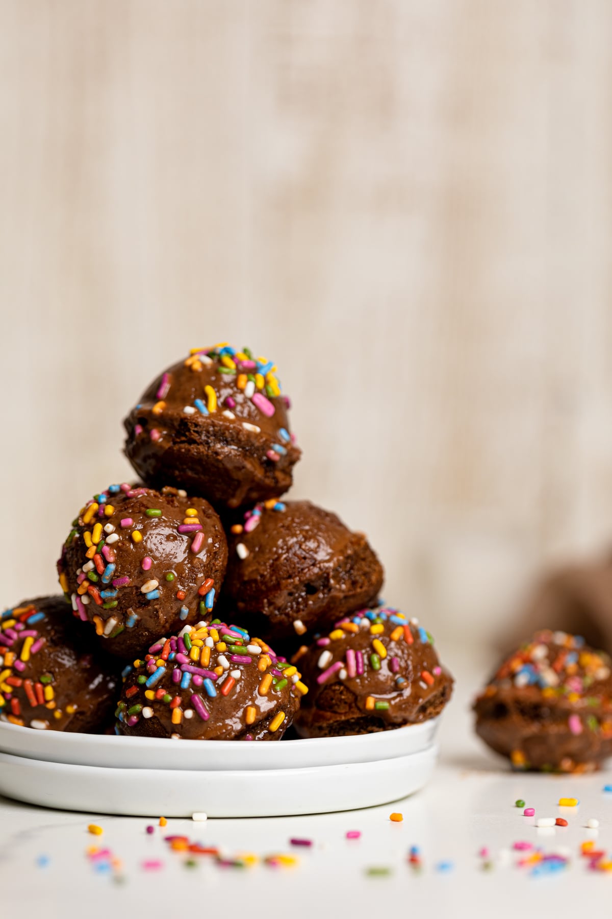 Pile of Vegan Chocolate Donut Holes on two small, stacked plates