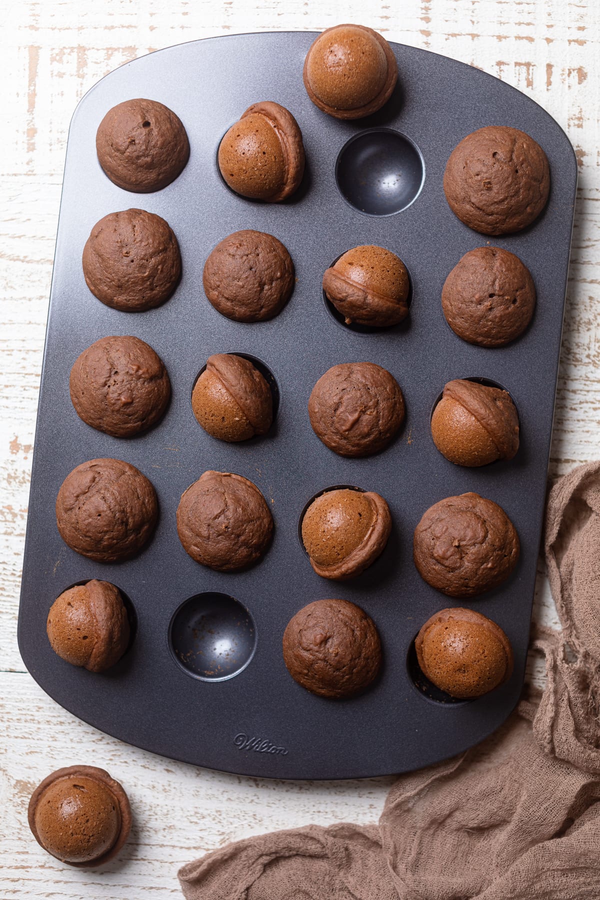 Vegan Chocolate Donut Holes in a donut hole pan with a few missing