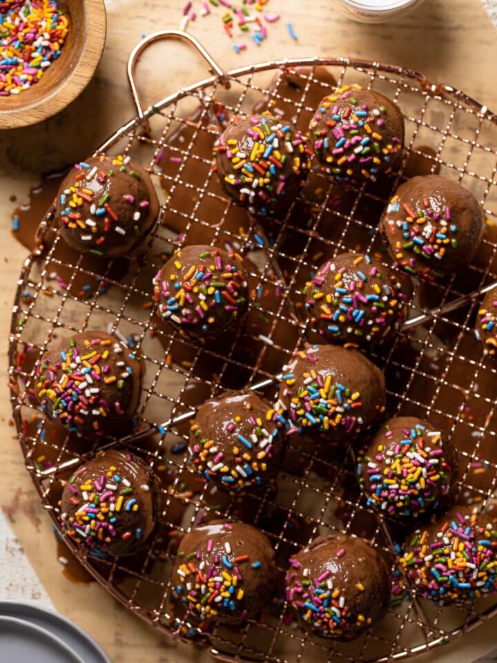 Vegan Chocolate Donut Holes on a wire rack