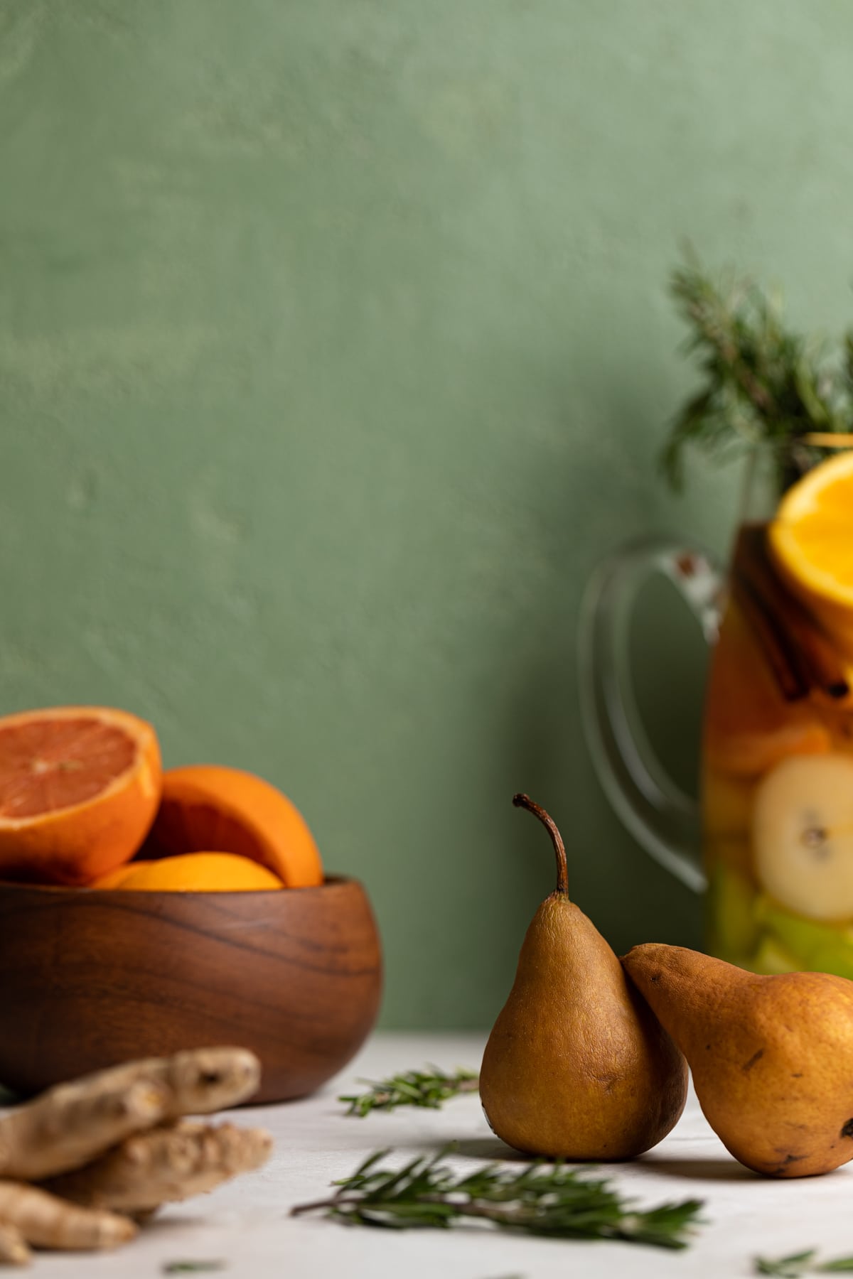 Pear, ginger, and other ingredients on a table.