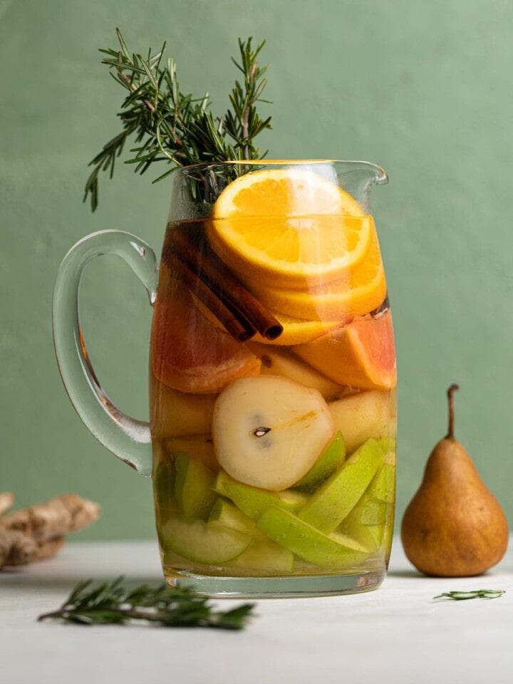 Citrus Ginger Pear Detox Infused Water in a glass pitcher.