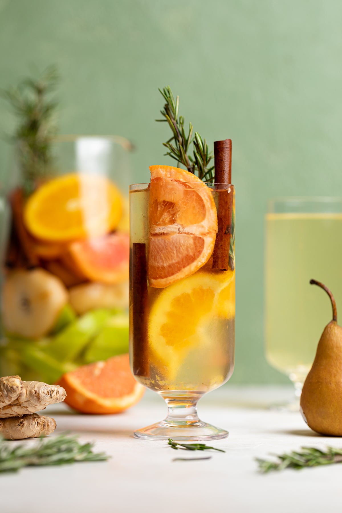 Citrus Ginger Pear Detox Infused Water and fruit in a tall glass.