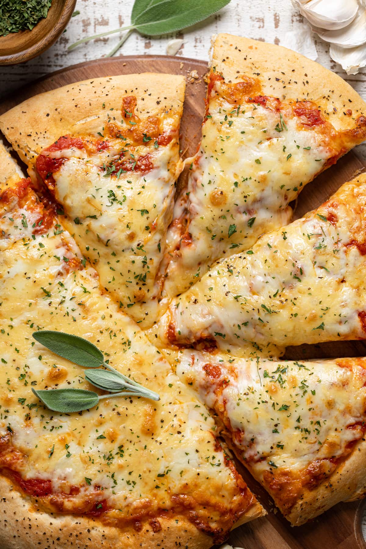 Closeup of a half-sliced Garlic Herb Cheese Pizza 