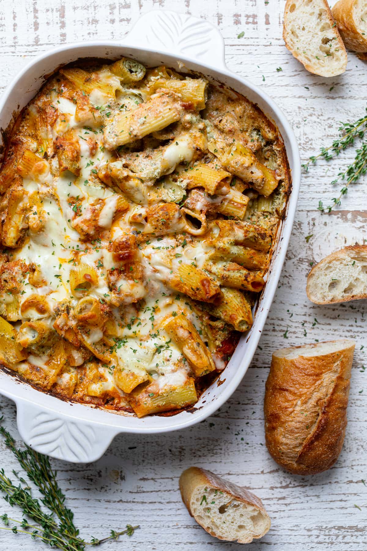 Pesto Pasta with Ricotta in a baking pan next to bread