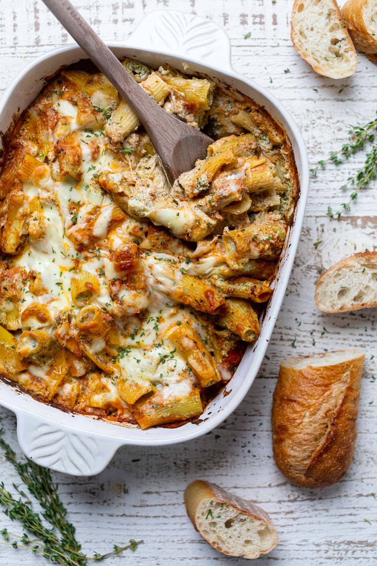 Wooden spoon in a baking pan of Pesto Pasta with Ricotta