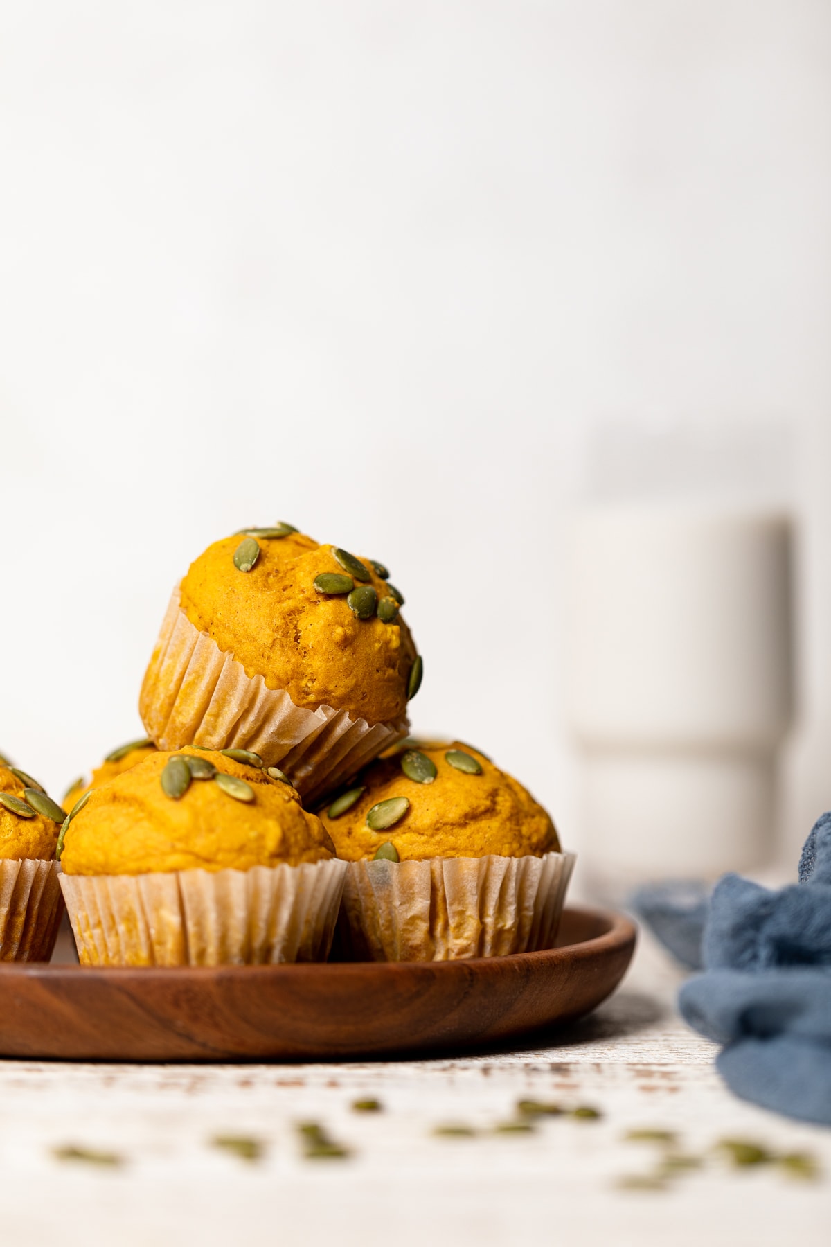 Pile of Vegan Pumpkin Spice Muffins on a wooden plate