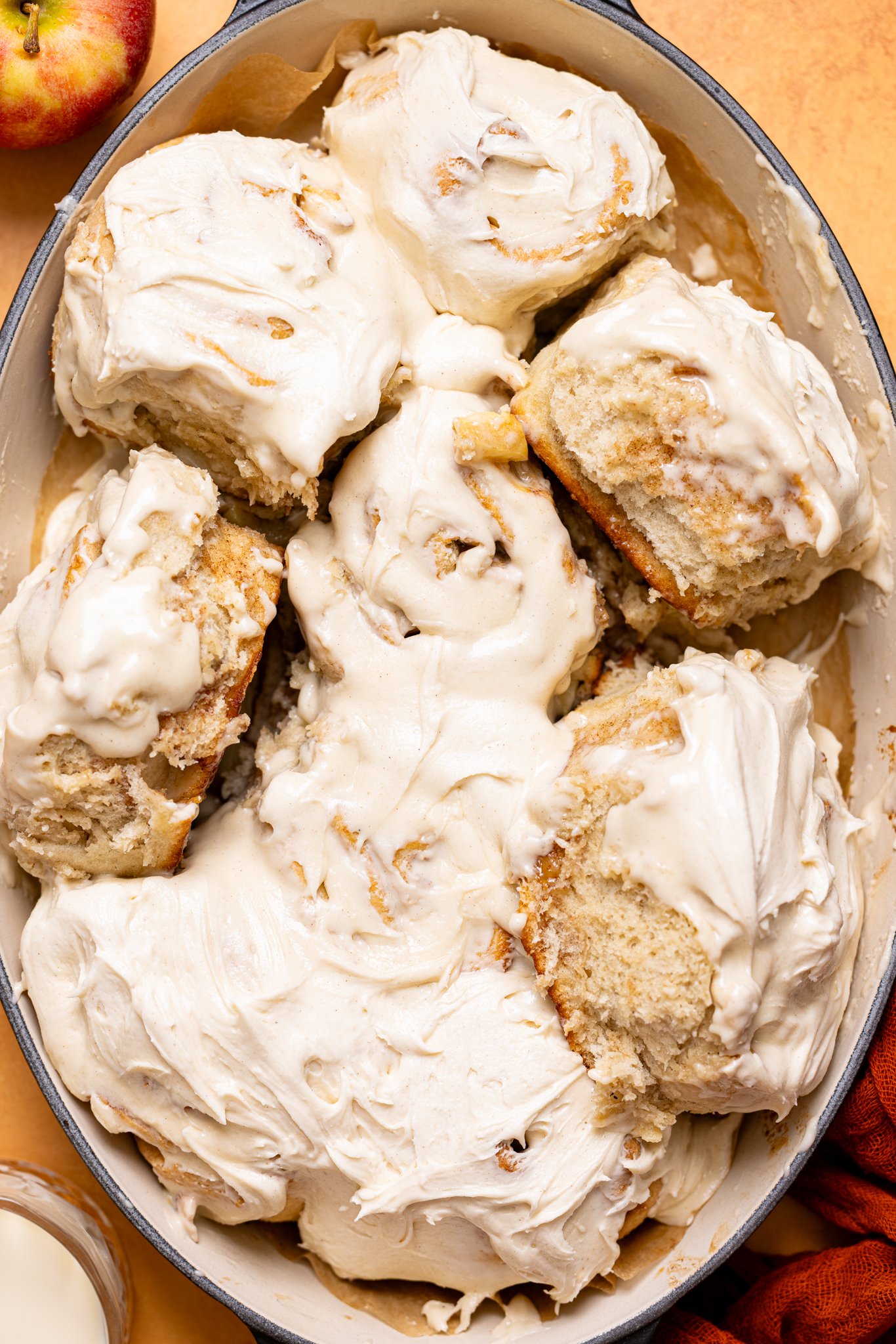 Up close shot of apple pie cinnamon rolls in a baking dish.