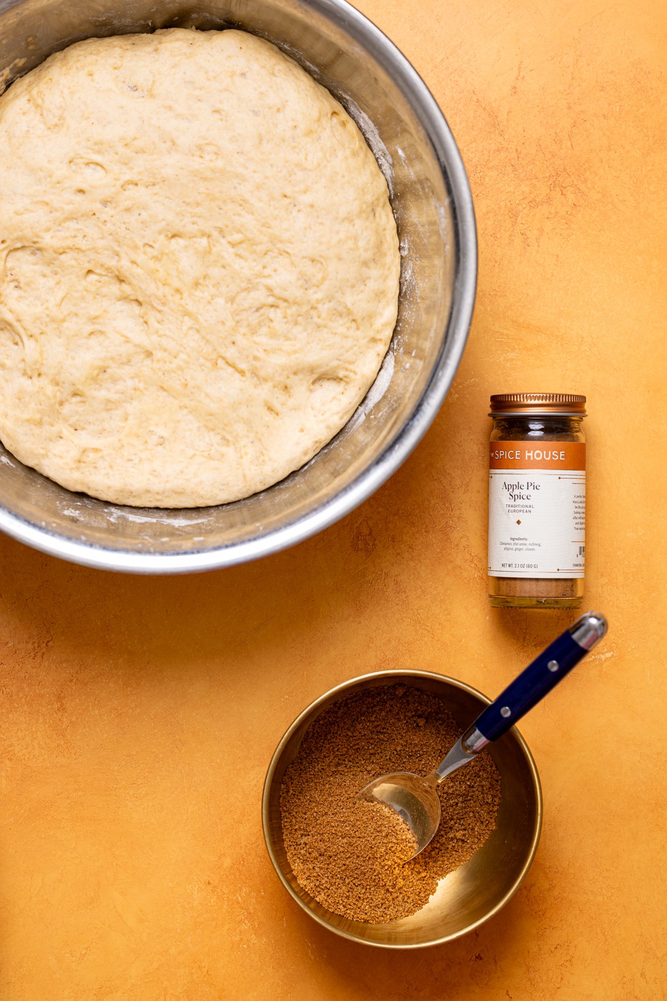 Image of cinnamon roll dough in a bowl with filling ingredients stirred together.