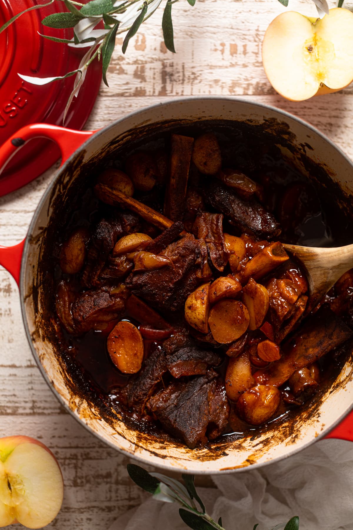 Slow cooked Braised Apple BBQ meat and Potatoes in a Dutch oven