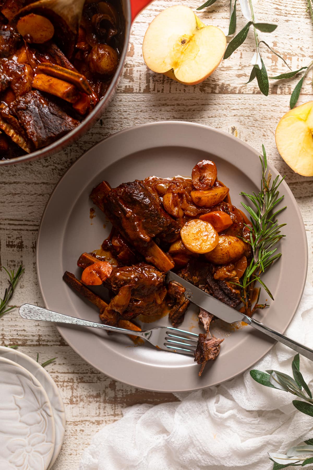 Plate with silverware and Braised Apple Barbeque Ribs with Potatoes