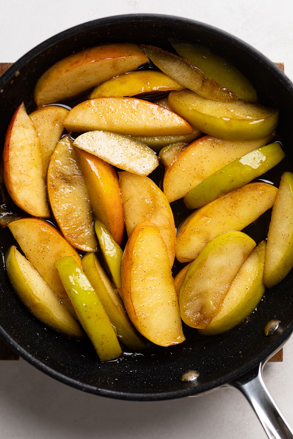 Seasoned apple slices in a pan