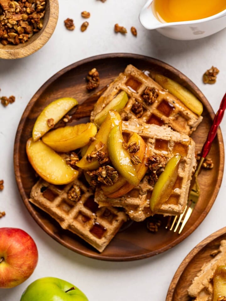 Apple Spice Cornmeal Waffles on a wooden plate with a fork