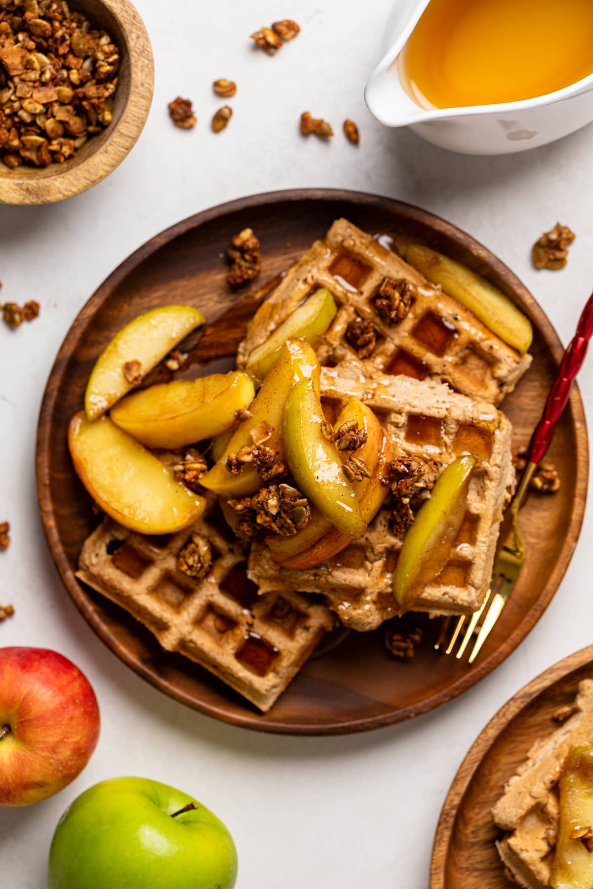 Apple Spice Cornmeal Waffles on a wooden plate with a fork