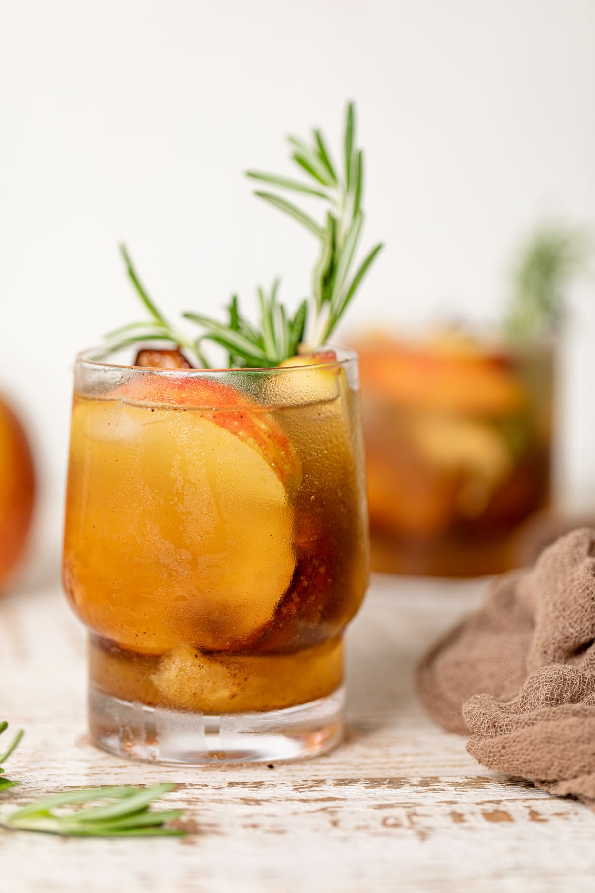 Roasted Apple Pear Mocktail in a small glass on a white table