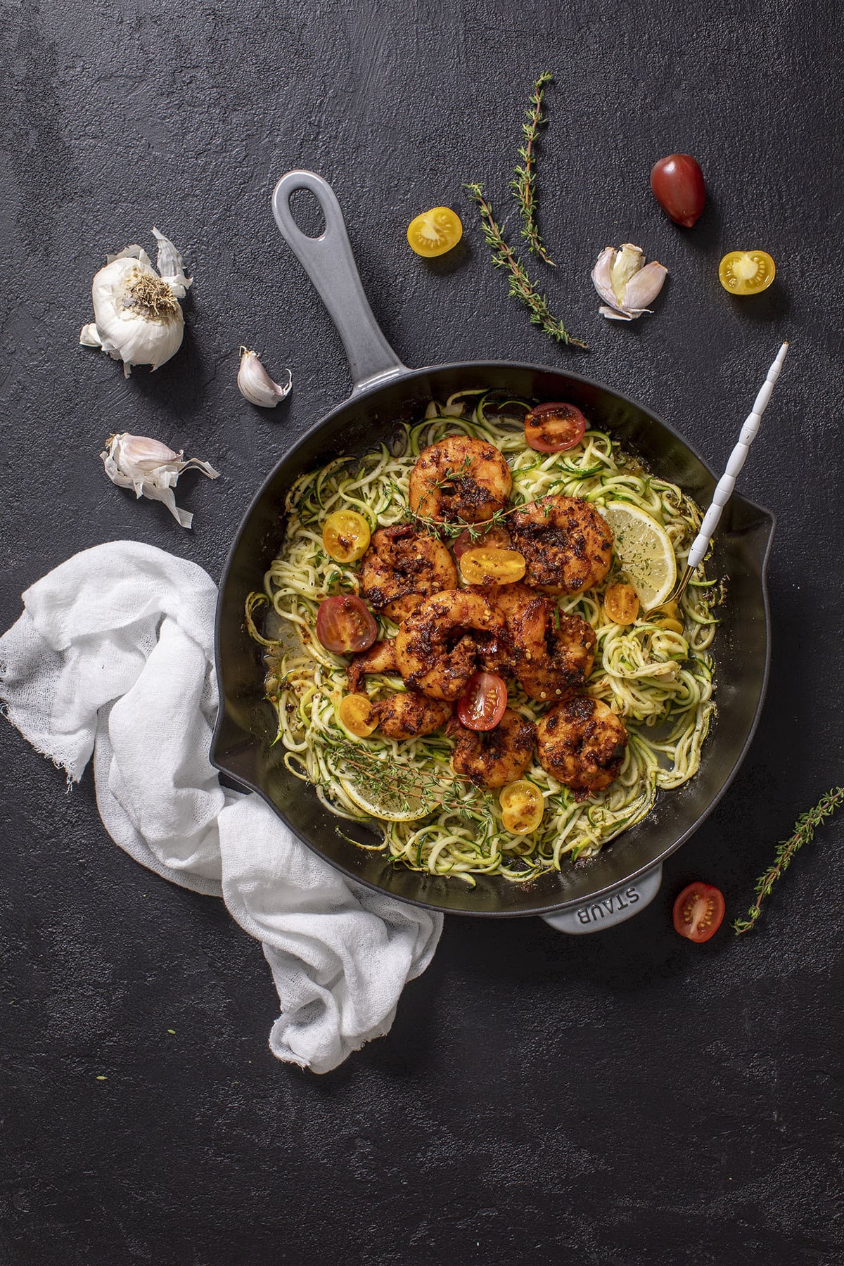Skillet of shrimp on a bed of zucchini noodles