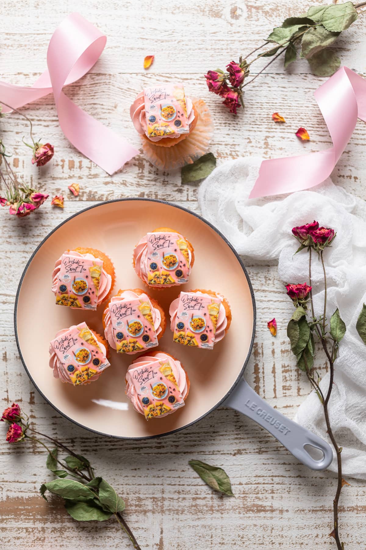 Cupcakes topped with edible Orchids + Sweet Tea cookbook covers