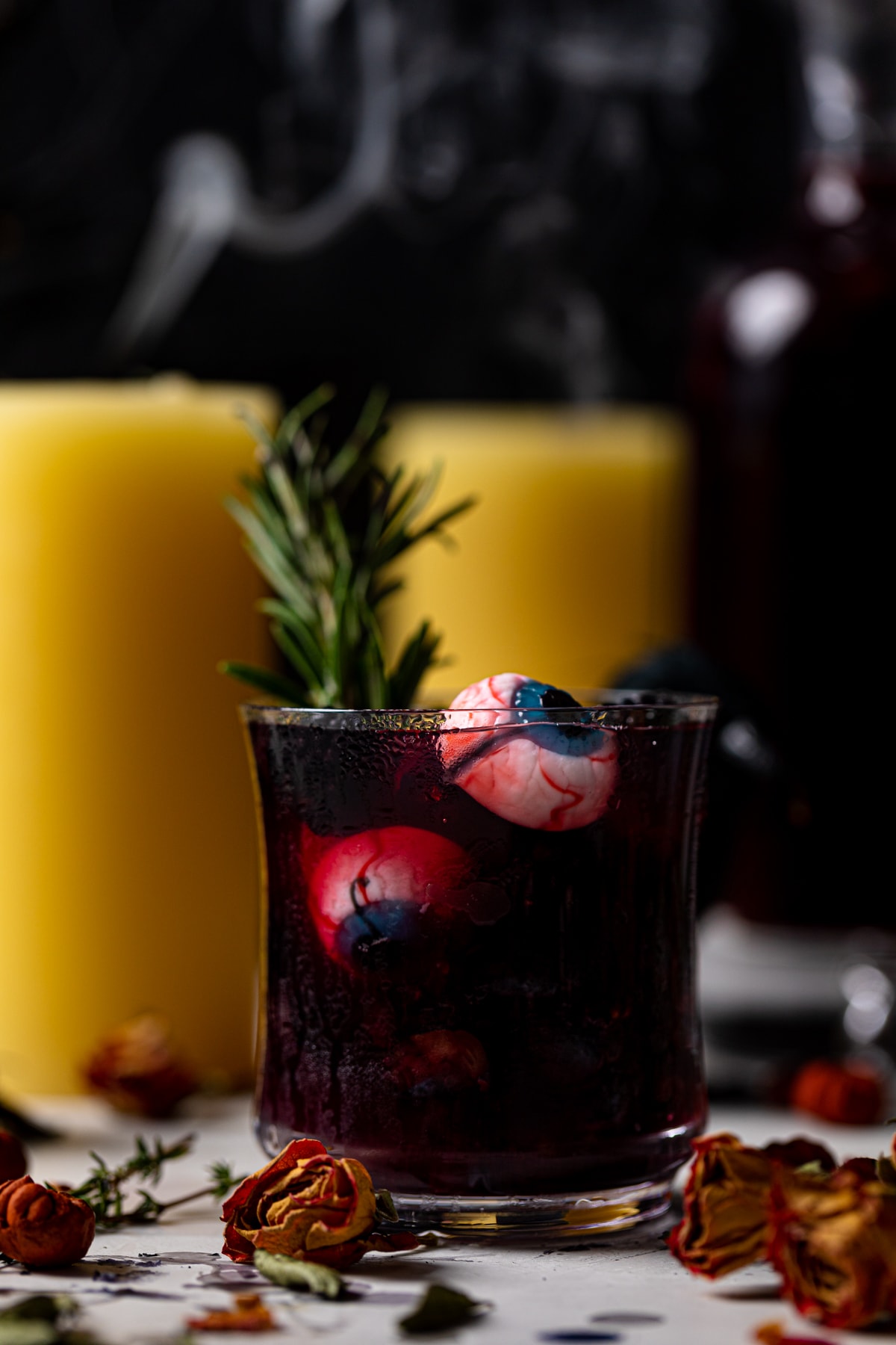 Closeup of edible eyes floating in a dark Blueberry Blackberry Mocktail 