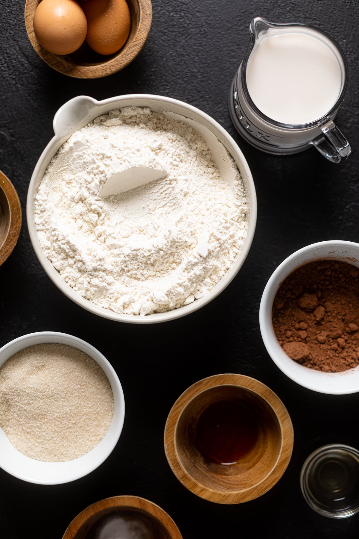 Ingredients for Black Widow Red Velvet Cake including flour, eggs, and cocoa powder