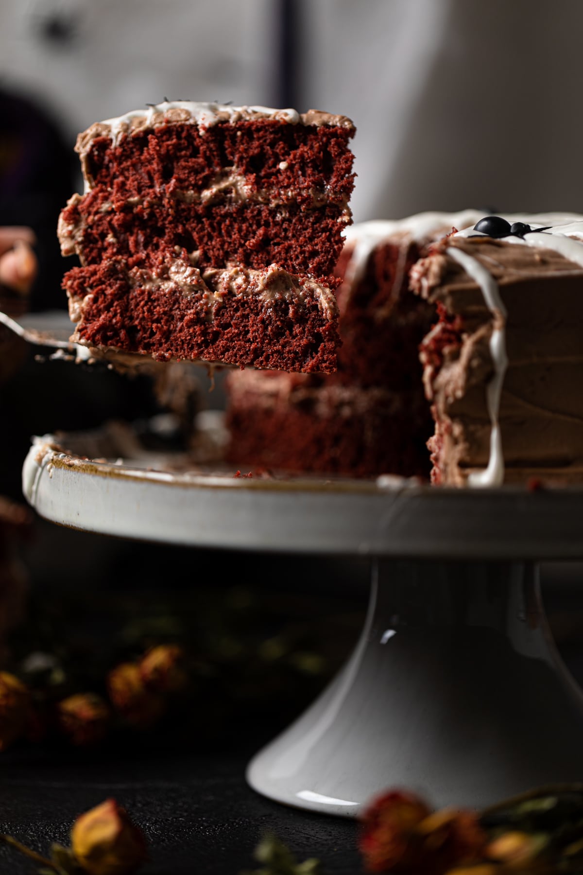 Spatula grabbing a slice from a Black Widow Red Velvet Cake