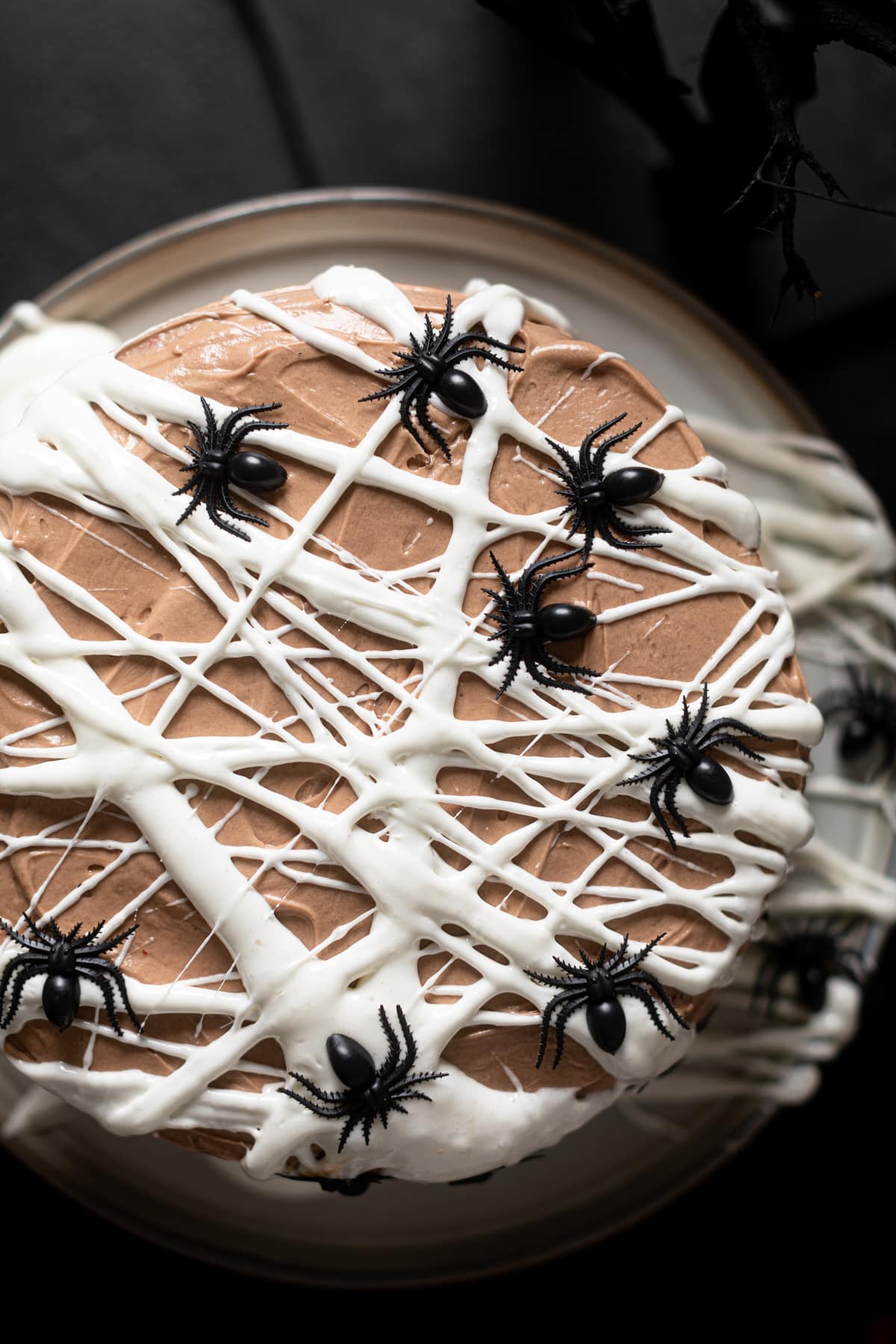 Black Widow Red Velvet Cake criss-crossed with cream cheese buttercream and black spiders