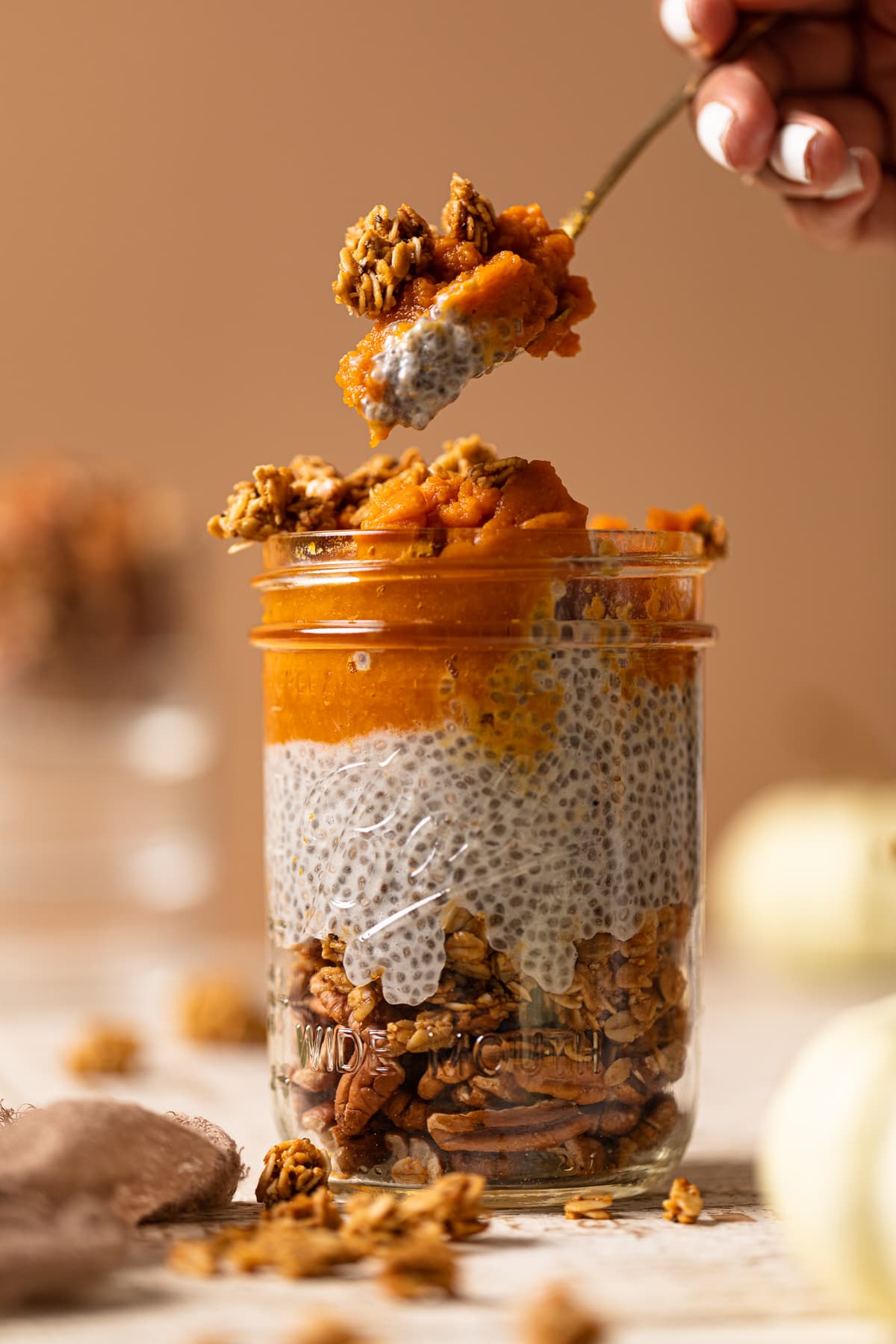 Spoon scooping from a jar of Pumpkin Pie Chia Pudding
