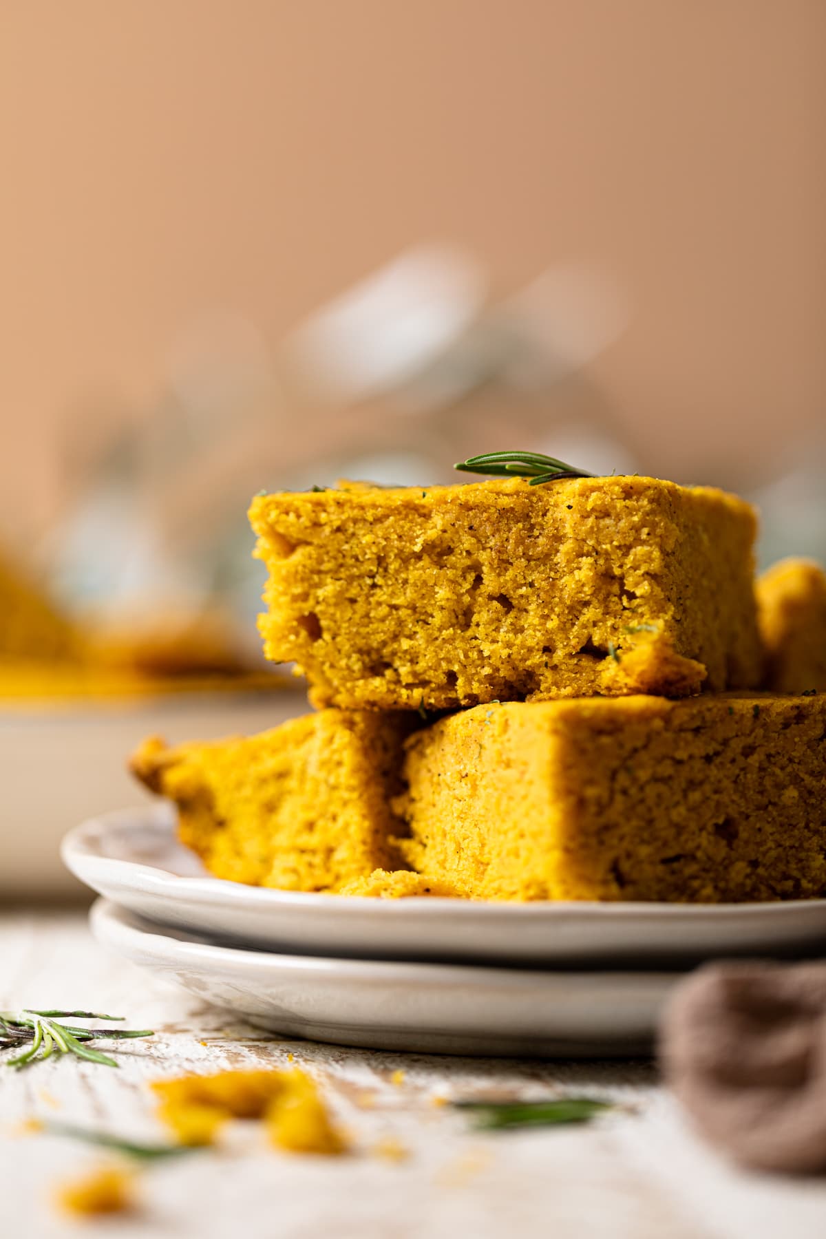 Pieces of Brown Butter Pumpkin Cornbread on two small, stacked plates