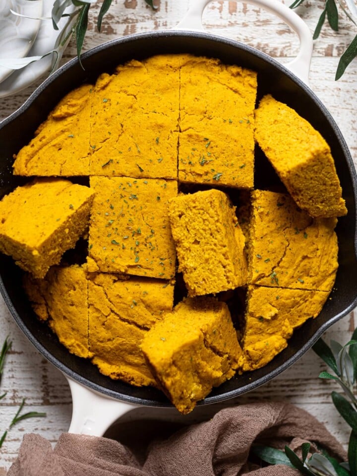 Skillet of sliced Brown Butter Pumpkin Cornbread