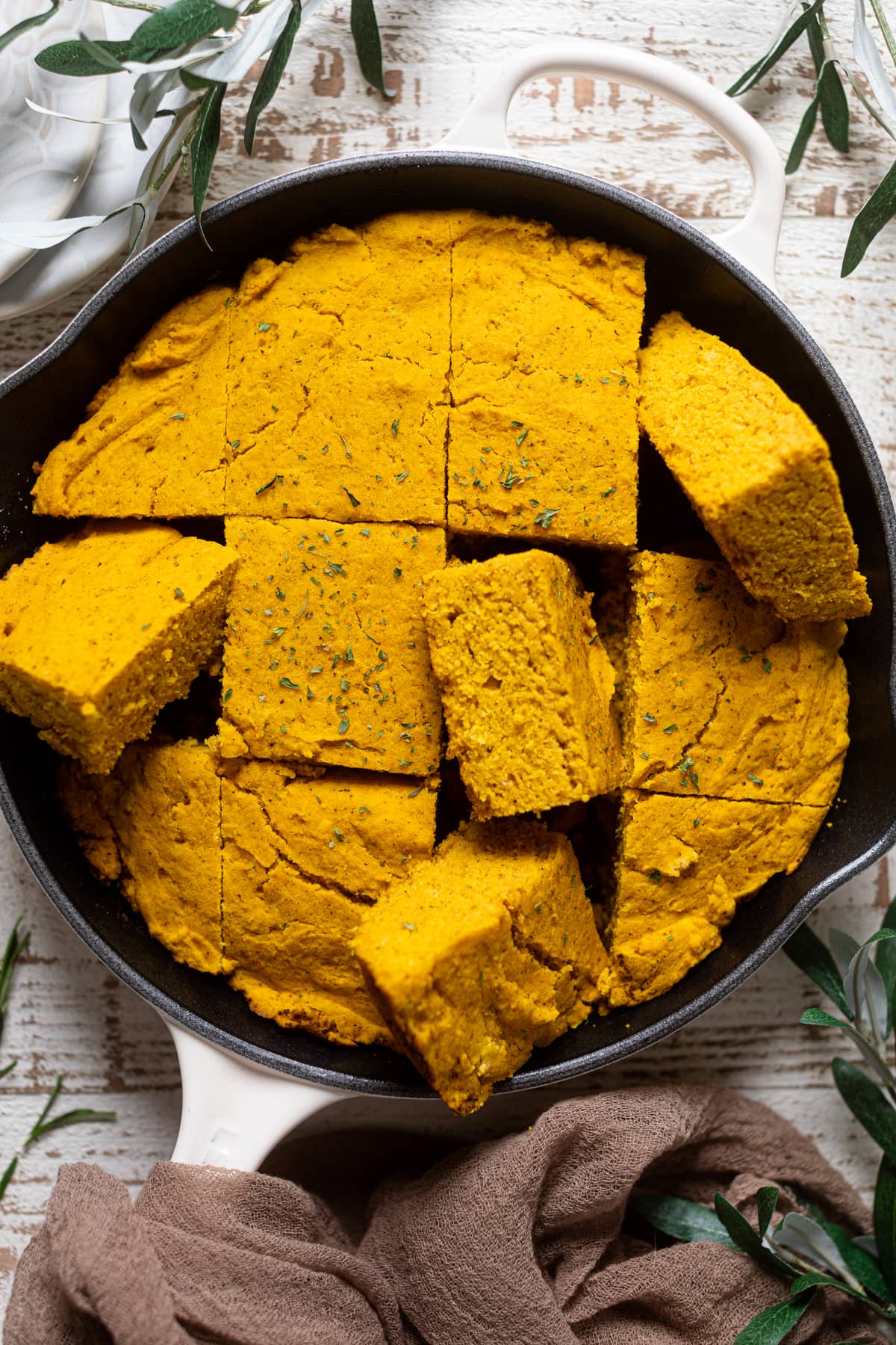 Skillet of sliced Brown Butter Pumpkin Cornbread