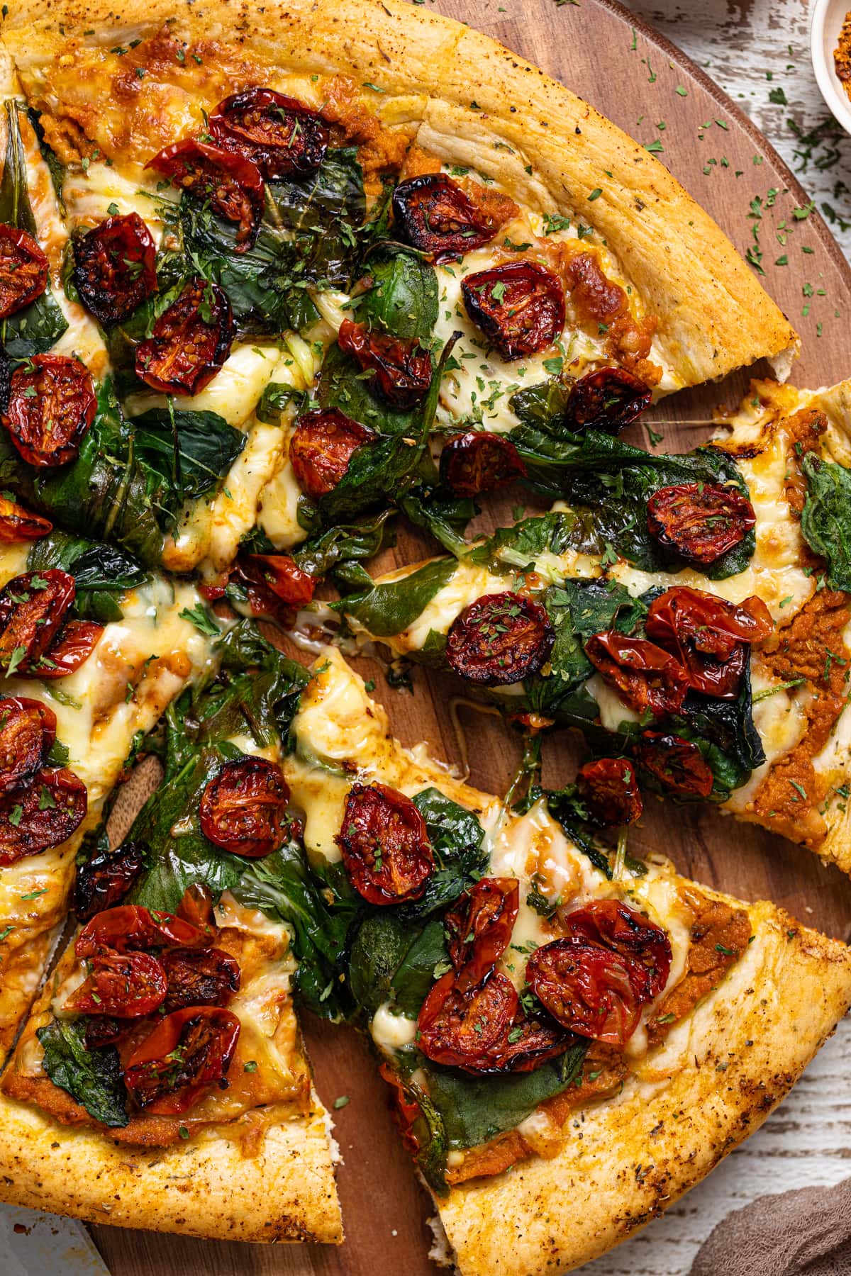 Cajun Roasted Veggie Pumpkin Pizza with a slice pulled out