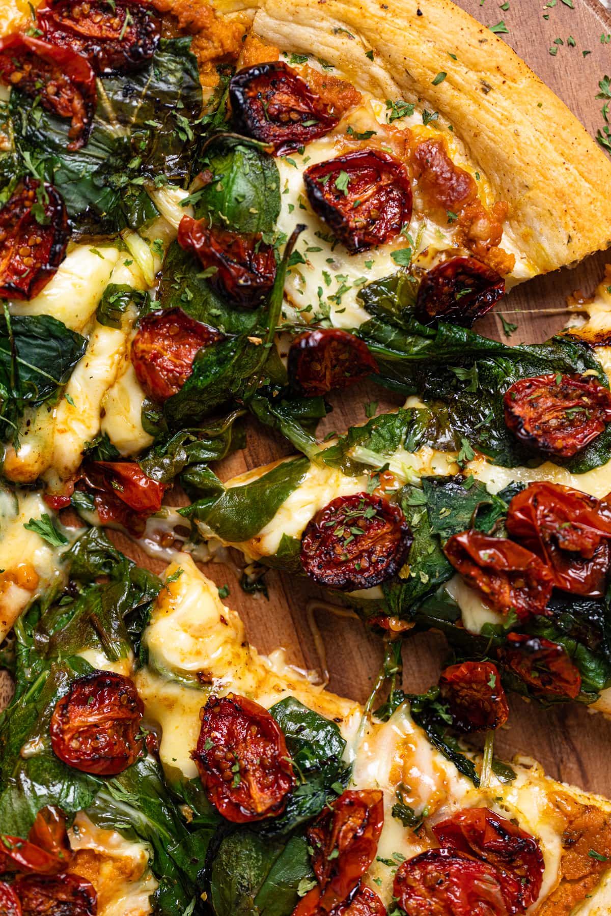 Cajun Roasted Veggie Pumpkin Pizza with a slice pulled out