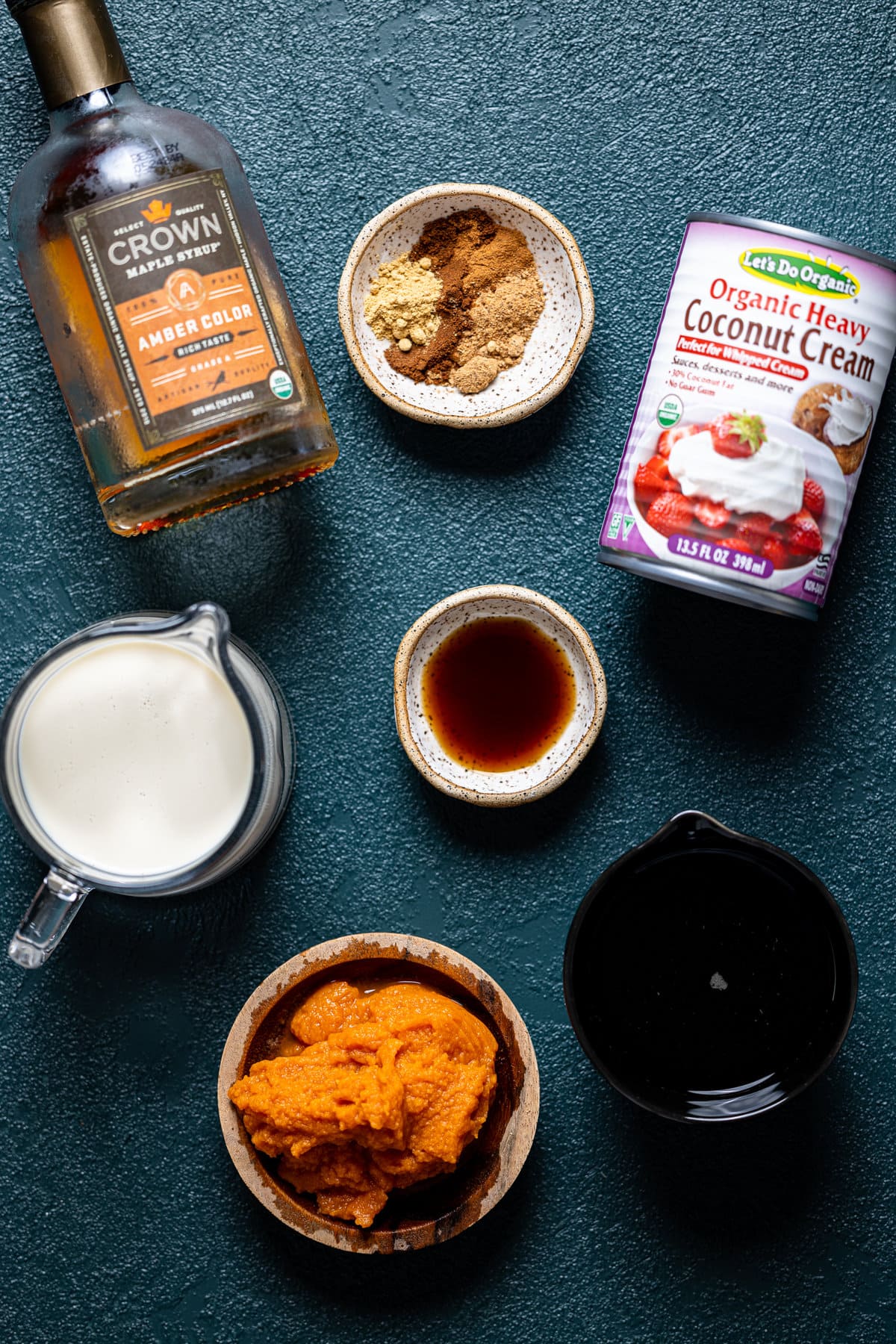 Ingredients for Dairy-Free Iced Pumpkin Spice Latte including coconut cream, maple syrup, and pumpkin puree
