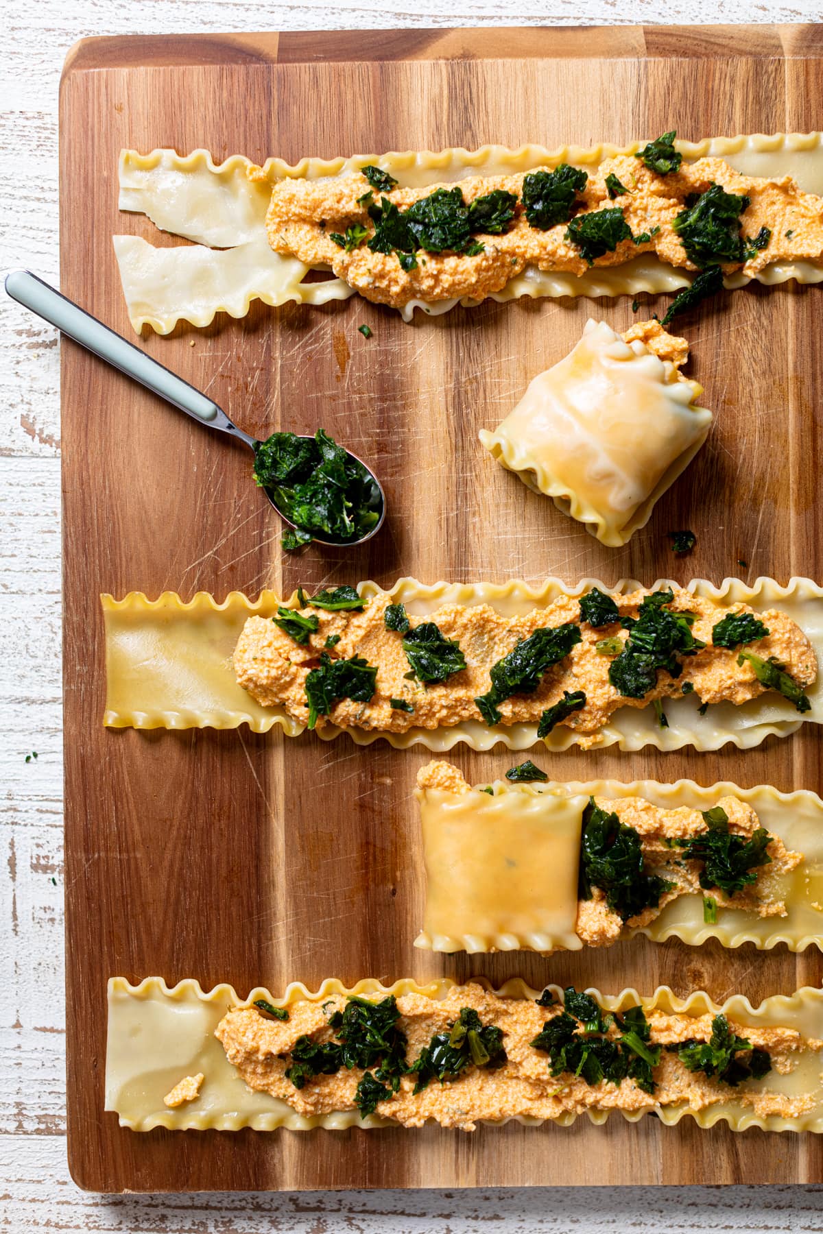 Lasagna noodles laid flat with pumpkin-ricotta mixture spooned onto them