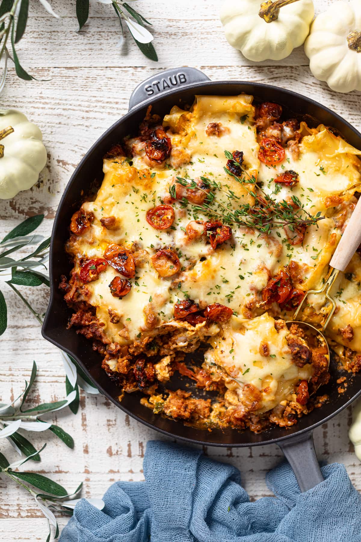 Spoon scooping Meatless Pumpkin Lasagna from a skillet