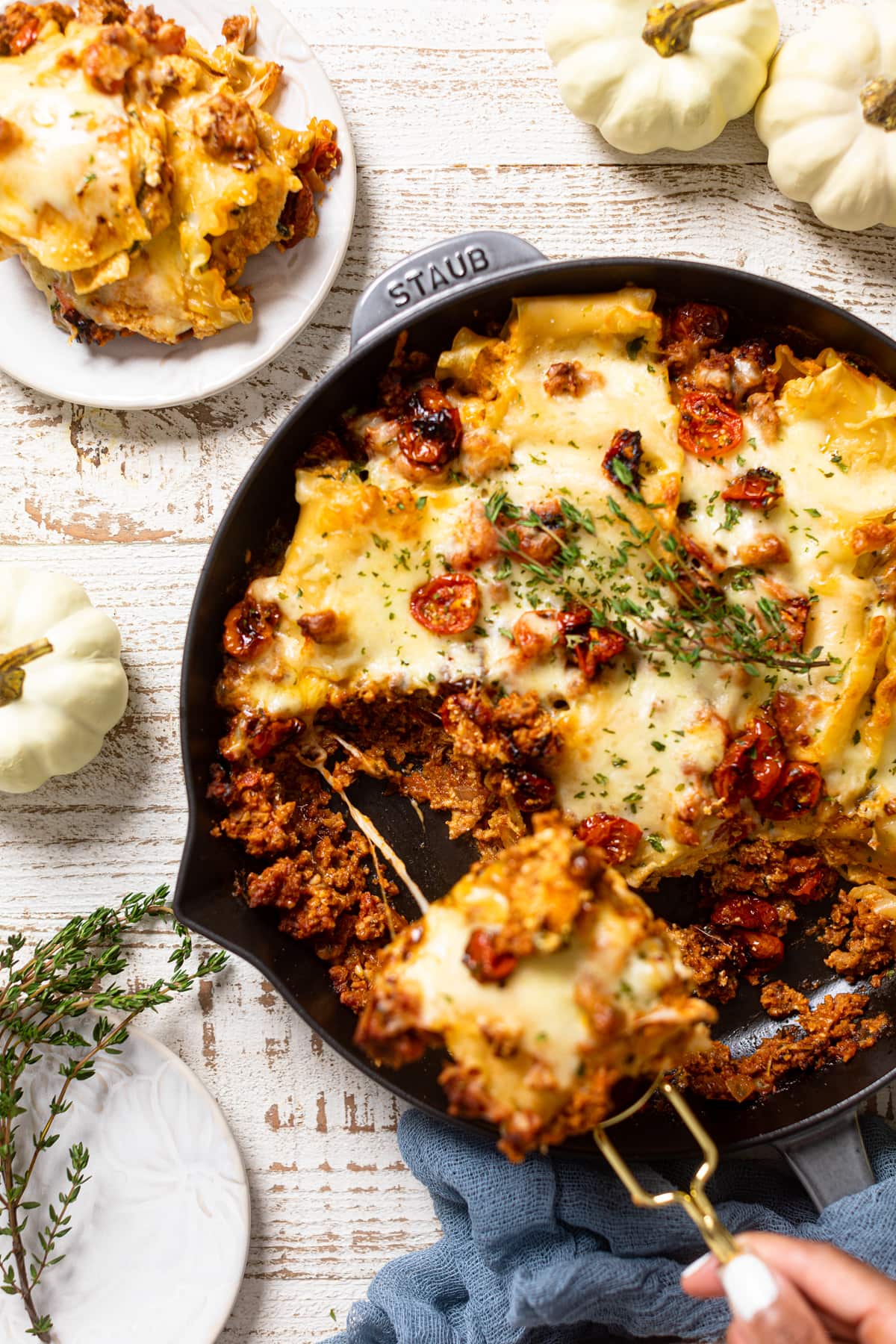 Piece being pulled out of a skillet of Meatless Pumpkin Lasagna