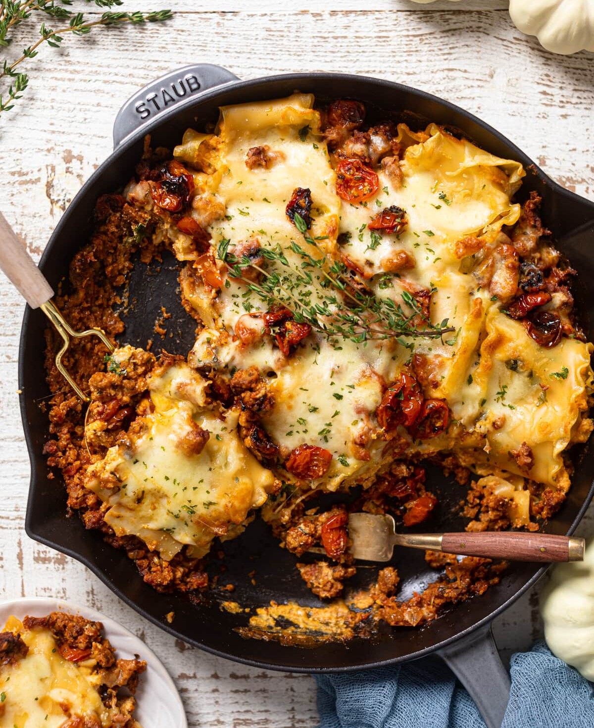 Half-served Meatless Pumpkin Lasagna in a skillet. Part of the fall pasta recipes roundup. 