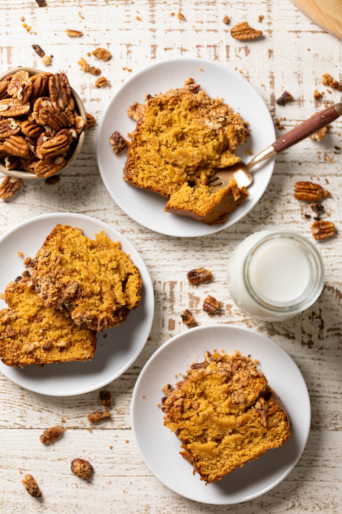 Slices of Vegan Sweet Potato Crumble Bread on small plates on a white table