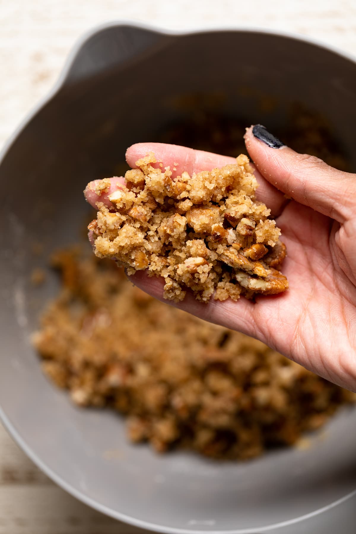 Hand holding crumble topping