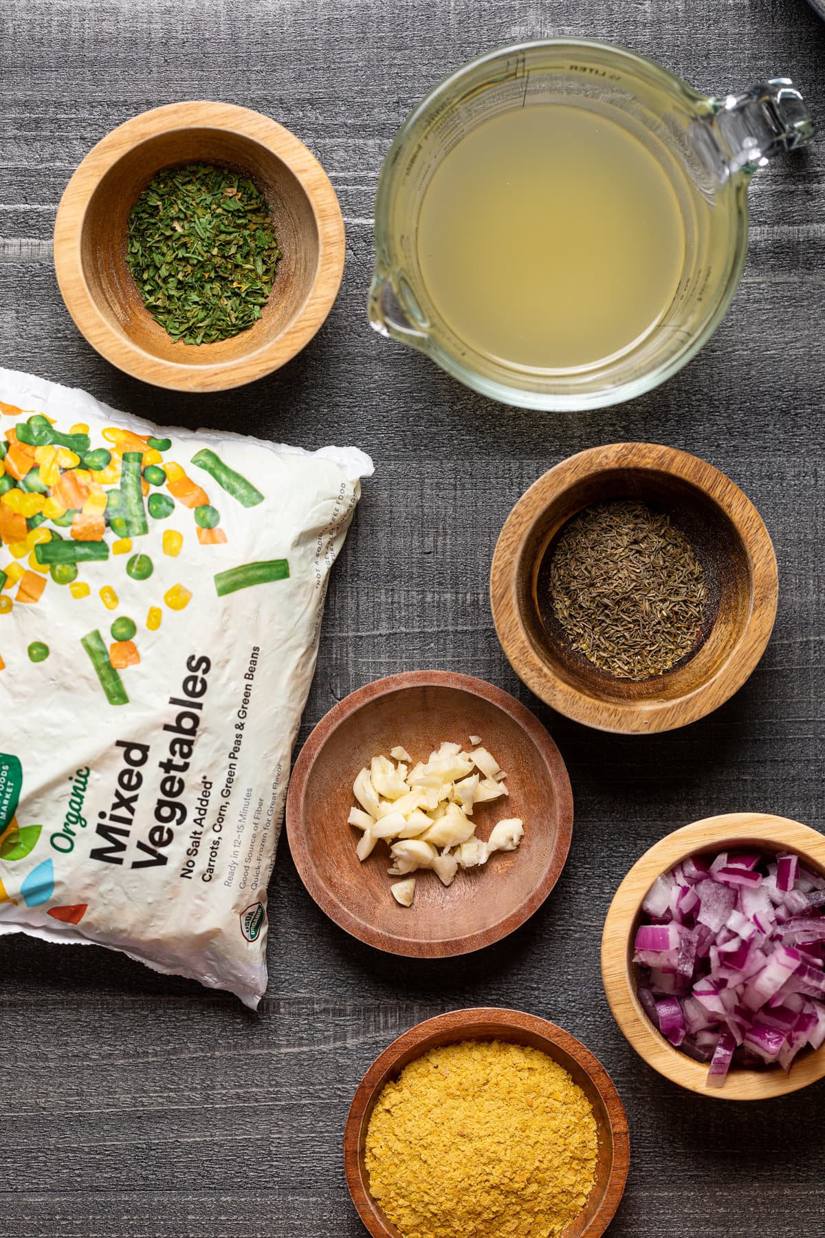 Ingredients for Vegan Pot Pie including frozen mixed vegetables, garlic, and red onion.