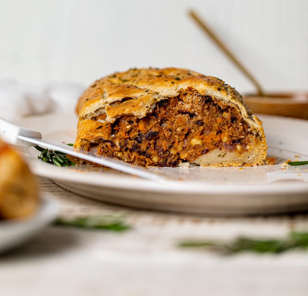 Vegan barbeque Wellington on a white serving platter