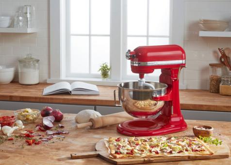 Red Kitchenaid stand mixer on a counter full of food