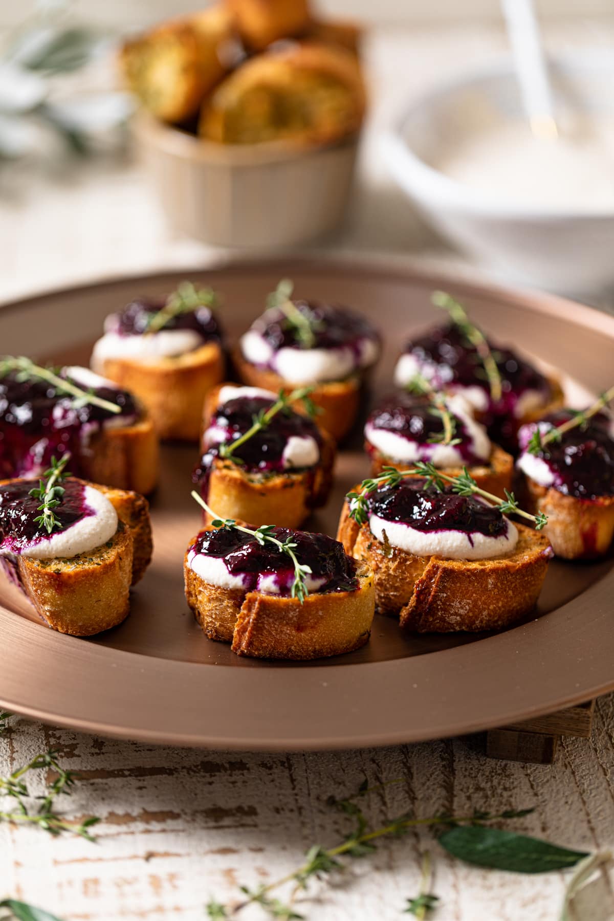 Vegan Blueberry Crostinis on a elevated, round serving dish